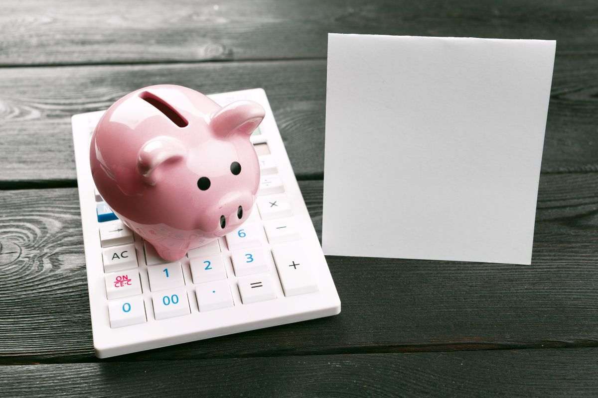 Salvadanaio, calcolatrice e block notes