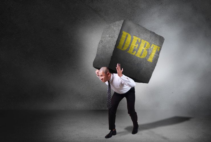 Persona con il fardello del debito pubblico sulle spalle