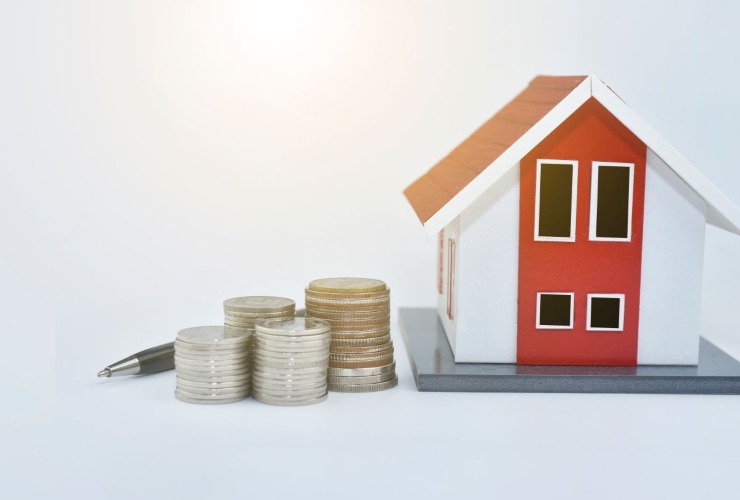 Monete e casa in miniatura